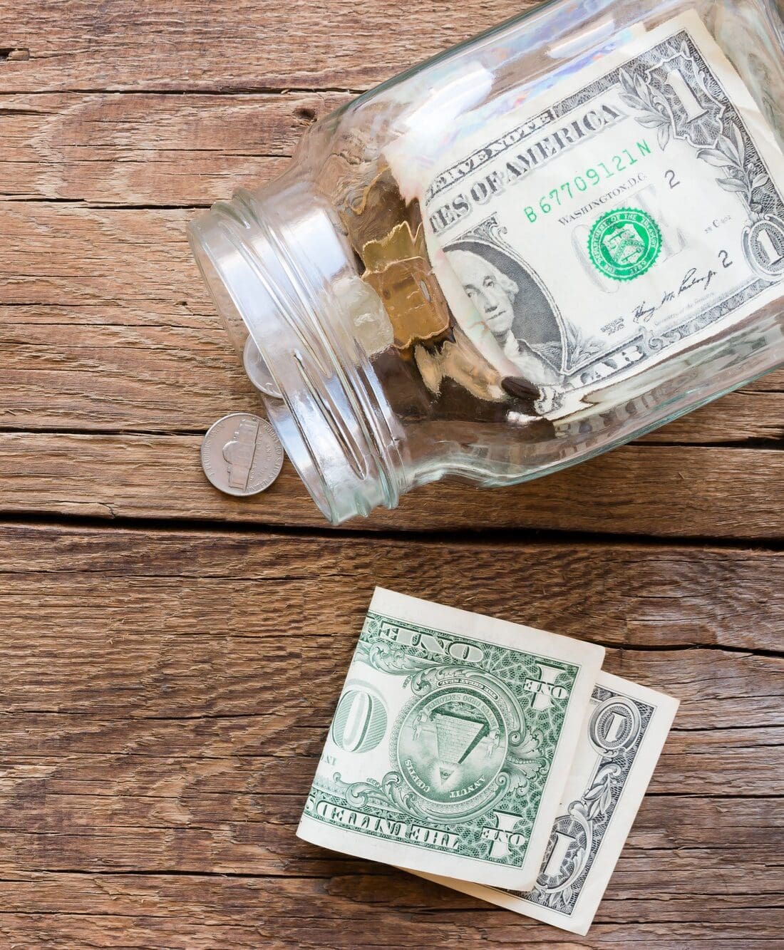 jar for donations with scattered money