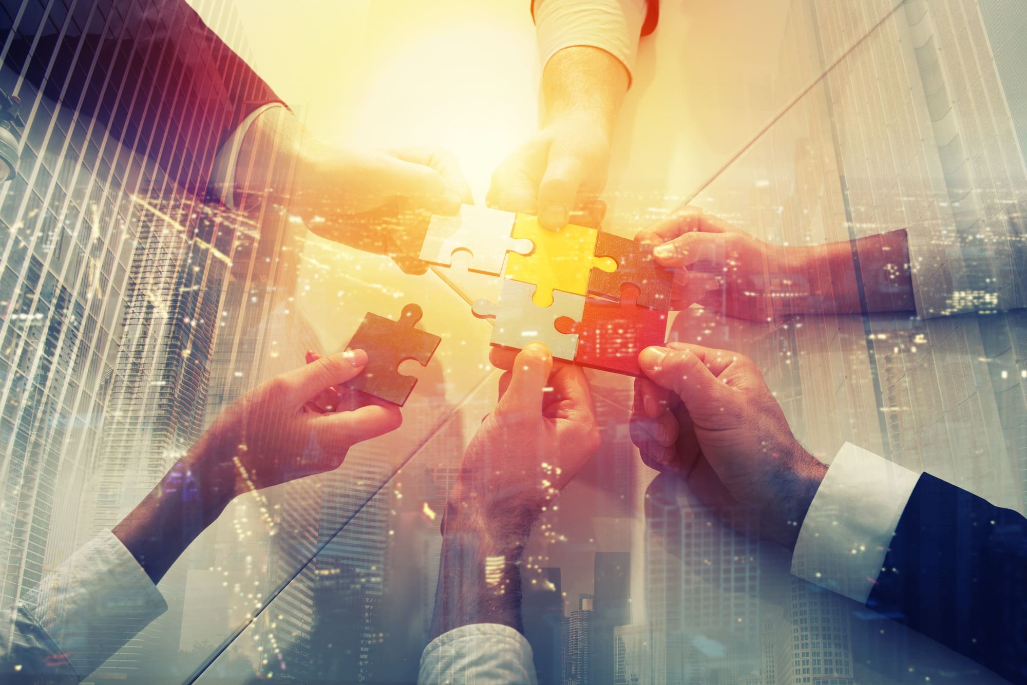 Teamwork of partners. Concept of integration and startup with puzzle pieces. double exposure